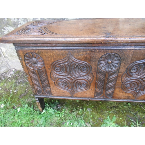 26 - A small 18th century oak coffer of six plank construction with carved decoration width 34.5ins, heig... 