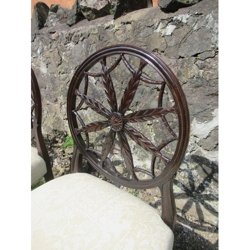 28 - A set of four 18th/19th century mahogany dining chairs, in the Hepplewhite style,  with circular bac... 