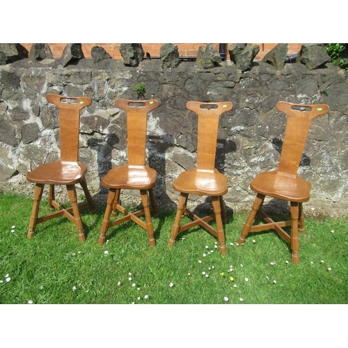 30 - Foxman Don Craven (Boroughbridge), a set of four oak spinning dining chairs, with handle aperture to... 