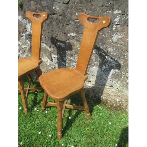 30 - Foxman Don Craven (Boroughbridge), a set of four oak spinning dining chairs, with handle aperture to... 