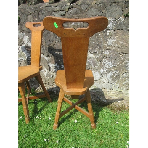 30 - Foxman Don Craven (Boroughbridge), a set of four oak spinning dining chairs, with handle aperture to... 