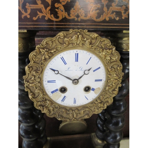 305 - A French clock with circular enamel dial supported by four turned columns with marquetery frieze and... 