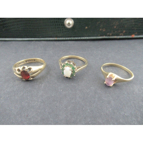 316 - A 9ct Ring claw set oval-cut garnet , a 9ct opal and emerald cluster Ring, a 9ct amethyst Ring, pinc... 