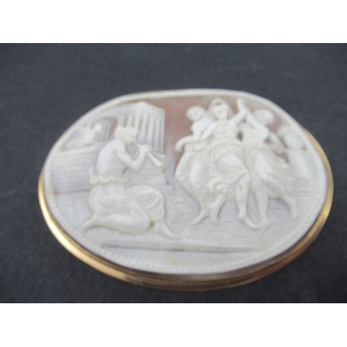 319 - An oval carved cameo brooch, decorated with a Classical scene of the three Graces' dancing and a pip... 