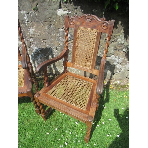 36 - A pair of Anglo Indian armchairs, with caned back and seats and carved decoration