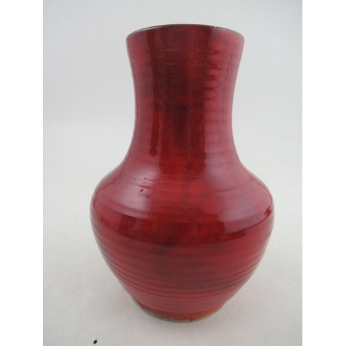 369 - A Moorcroft Pottery vase, decorated with a red Flambe glaze, height 7.25ins