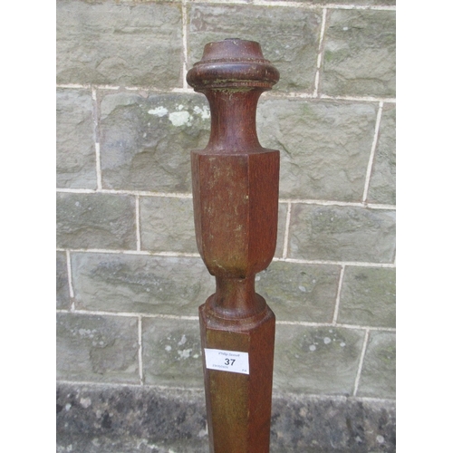 37 - An Arts and Crafts oak standard lamp, raised on a pedestal