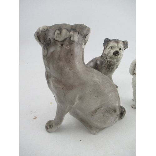 378 - Three porcelain models, of seated dogs, two of pug type dogs, the other of a Staffordshire style poo... 