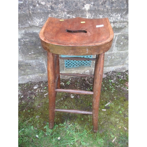 38 - A mahogany bar stool with shaped seat, raised on turned legs united by stretchers