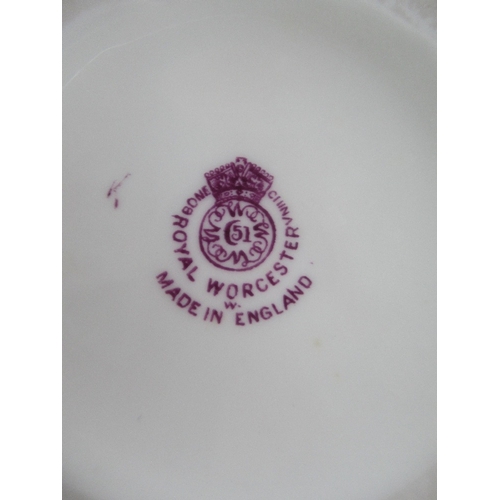 388 - A set of three graduated Royal Worcester jugs decorated with purple flowers to a white ground