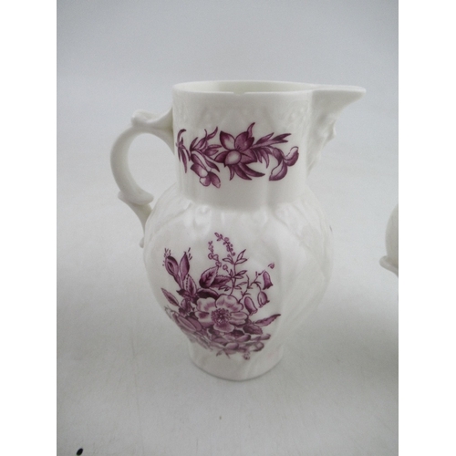 388 - A set of three graduated Royal Worcester jugs decorated with purple flowers to a white ground