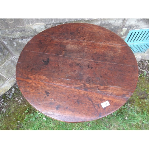 39 - A 19th century oak tilt top tripod table, diameter 27ins