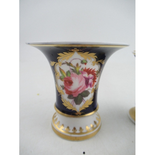 392 - Two Chamberlains spill Vases both with blue grounds the one reserving a panel of flowers the other a... 