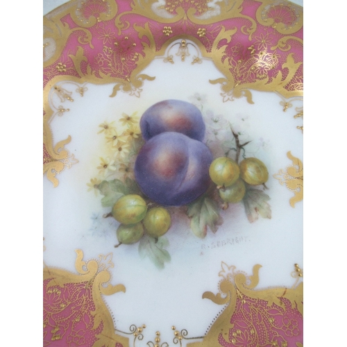 397 - A Royal Worcester plate decorated with damsons and gooseberries to a pink gilt richly enameled borde... 