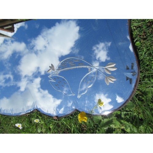 4 - An Edwardian oval mirror, together with another mirror with etched decoration