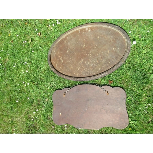 4 - An Edwardian oval mirror, together with another mirror with etched decoration