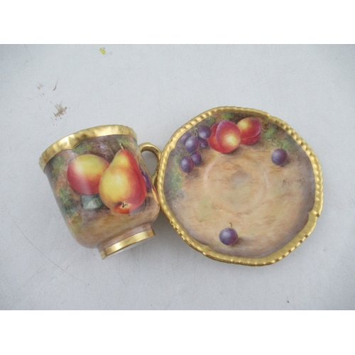 402 - A Royal Worcester coffee cup and saucer decorated with fruit by Freeman