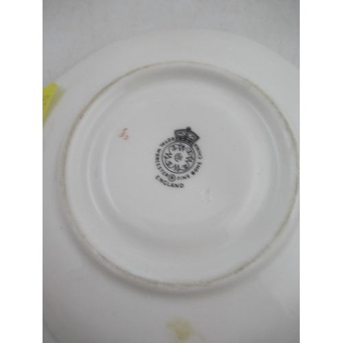 402 - A Royal Worcester coffee cup and saucer decorated with fruit by Freeman