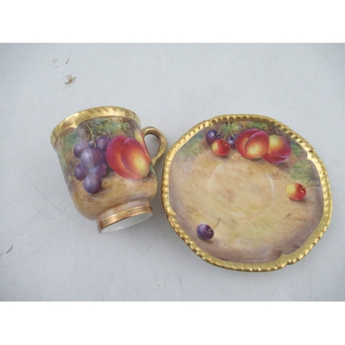 403 - A Royal Worcester coffee cup and saucer decorated with fruit by Freeman