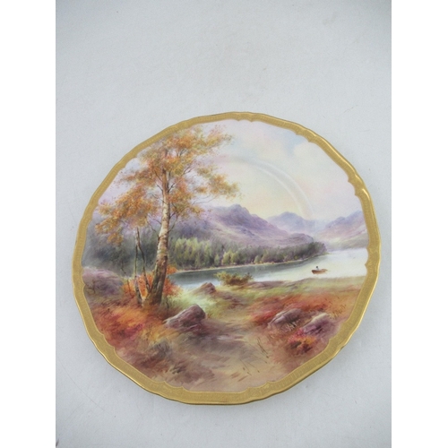 411 - A Royal Worcester plate decorated with a view of Derwent Water by Harry Davies to a gilt boarder dia... 