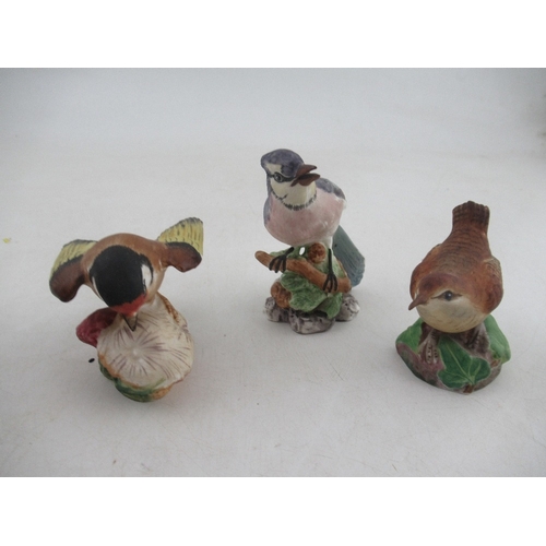 414 - A Royal Worcester parakeet boy together with  a model of blue jay, wren and a goldfinch