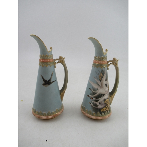 421 - A pair of left and Right Royal Worcester jugs each decorated with four swans on a powder blue ground... 