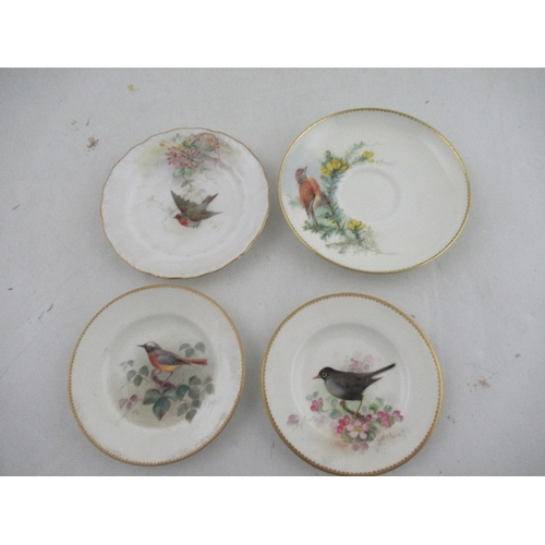 423 - Two Royal Worcester miniature plates decorated with a Red Start, Black bird, Robin and a Linnet by P... 