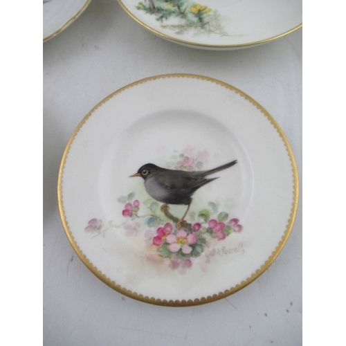 423 - Two Royal Worcester miniature plates decorated with a Red Start, Black bird, Robin and a Linnet by P... 