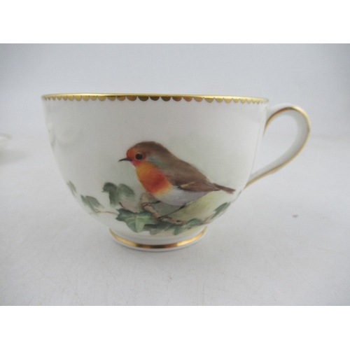 425 - A Royal Worcester cup decorated with a robin  saucer decorated with a Linnet and side plate decorate... 