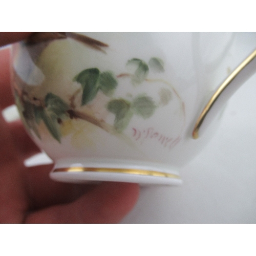 425 - A Royal Worcester cup decorated with a robin  saucer decorated with a Linnet and side plate decorate... 