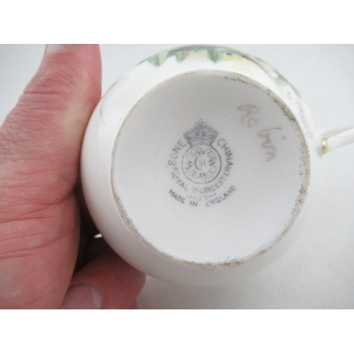 425 - A Royal Worcester cup decorated with a robin  saucer decorated with a Linnet and side plate decorate... 