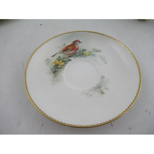 425 - A Royal Worcester cup decorated with a robin  saucer decorated with a Linnet and side plate decorate... 