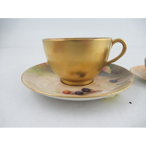 430 - A Royal Worcester tea cup and saucer decorated with fruit by Austin and Price together with a miniat... 