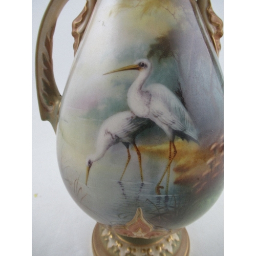 462 - A Royal Worcester vase, the front decorated with two storks wading by Lewis and a landscape to the r... 