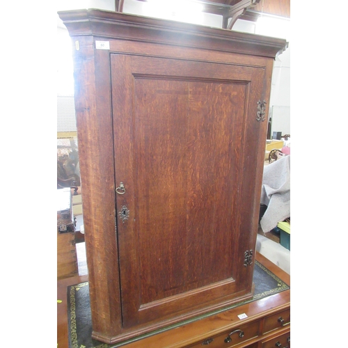 60 - A Georgian oak corner cupboard, width 34ins