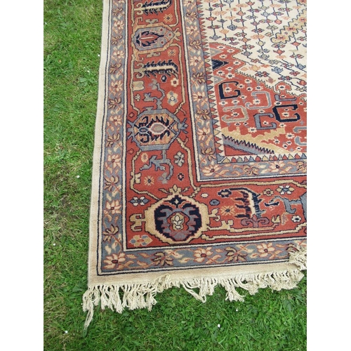 86 - A large Super Keshan rug, made in Belgium, with geometric design to a red and cream ground, 162ins x... 