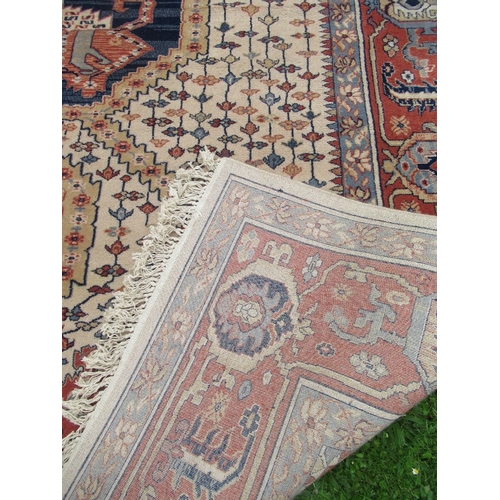 86 - A large Super Keshan rug, made in Belgium, with geometric design to a red and cream ground, 162ins x... 