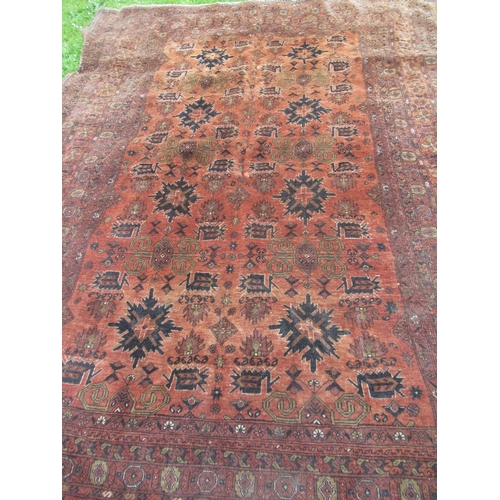 88 - An Eastern design rug, decorated with geometric design to a rust ground