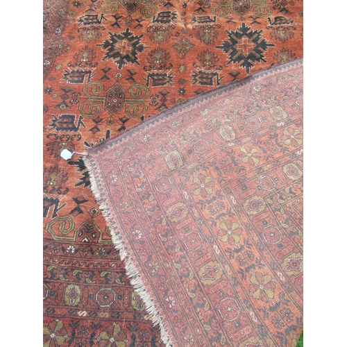 88 - An Eastern design rug, decorated with geometric design to a rust ground