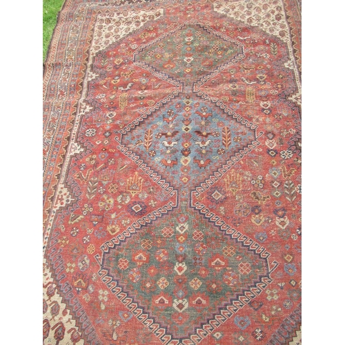 89 - An Eastern design rug, decorated with  geometric foliate patterns and animals, 66ins x 92ins