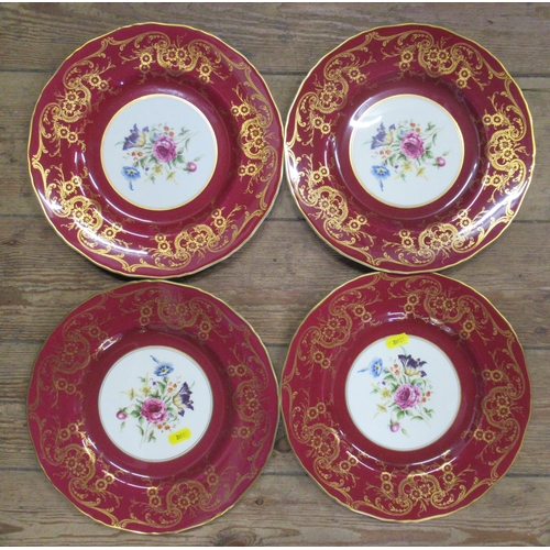 123 - Four Royal Worcester plates, decorated with flowers to a red and gold border