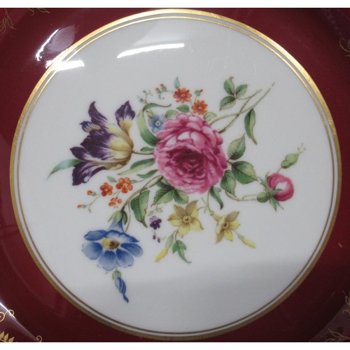 123 - Four Royal Worcester plates, decorated with flowers to a red and gold border