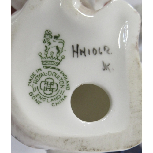 132 - A Royal Doulton model, of a seated spaniel with a pheasant, together with a pair of Staffordshire mo... 