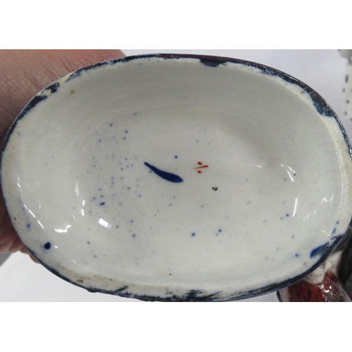 132 - A Royal Doulton model, of a seated spaniel with a pheasant, together with a pair of Staffordshire mo... 