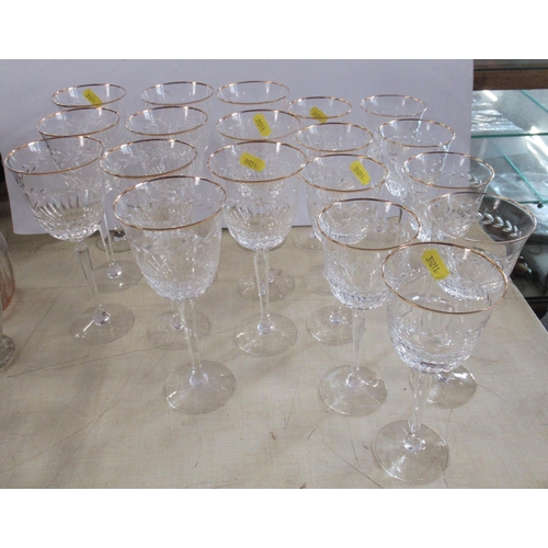 199 - A suite of glasses, to include 10 larger wine glasses and 9 smaller ones, with gilt rim