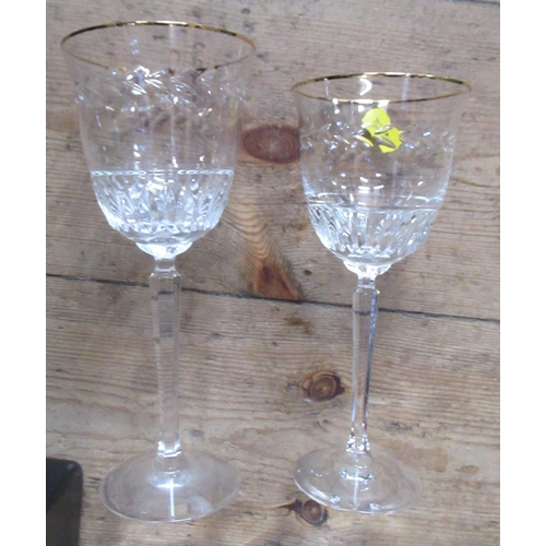 199 - A suite of glasses, to include 10 larger wine glasses and 9 smaller ones, with gilt rim