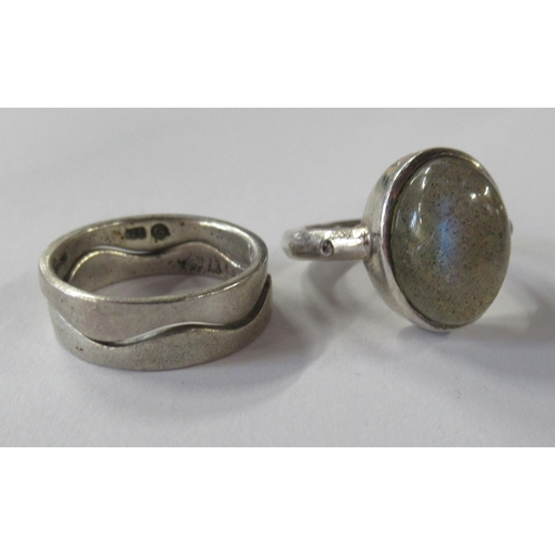211 - A silver coloured stacking ring, in two sections, together with a stone set ring