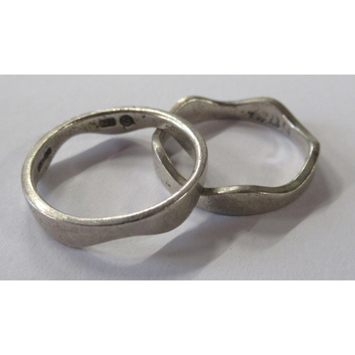 211 - A silver coloured stacking ring, in two sections, together with a stone set ring