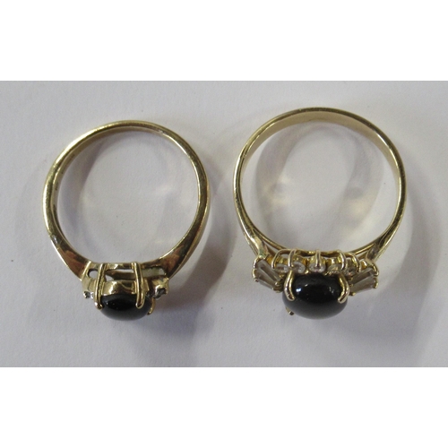 212 - A 9ct gold ring, set with a diopside star sapphire, together with another similar ring