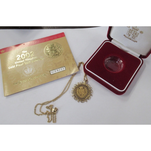 222 - A gold half sovereign, in gold pierced frame and with chain, total weight 10.7g